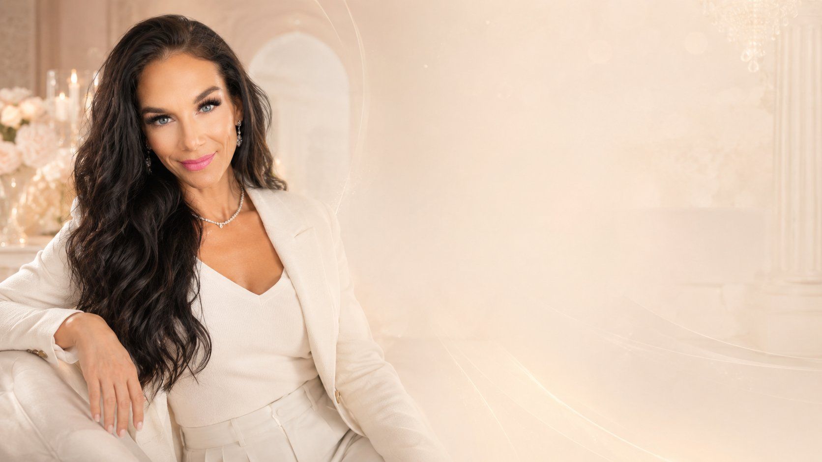 Lisa Marie Pepe seated in an ivory outfit in a warm, softly lit setting